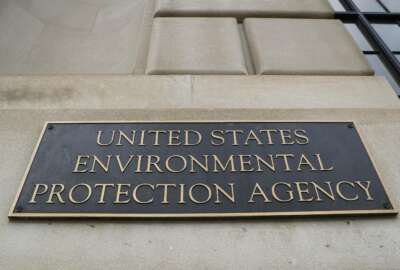 FILE - In this Sept. 21, 2017, file photo, the Environmental Protection Agency (EPA) Building is shown in Washington. Two high-ranking Trump political appointees at the EPA engaged in fraudulent payroll activities, including payments to employees after they were fired and to one of the officials when he was absent from work, that cost the agency more than $130,000, a report by an internal watchdog says. Former chief of staff Ryan Jackson and former White House liaison Charles Munoz submitted “official timesheets and personnel forms that contained materially false, fictitious, and fraudulent statements